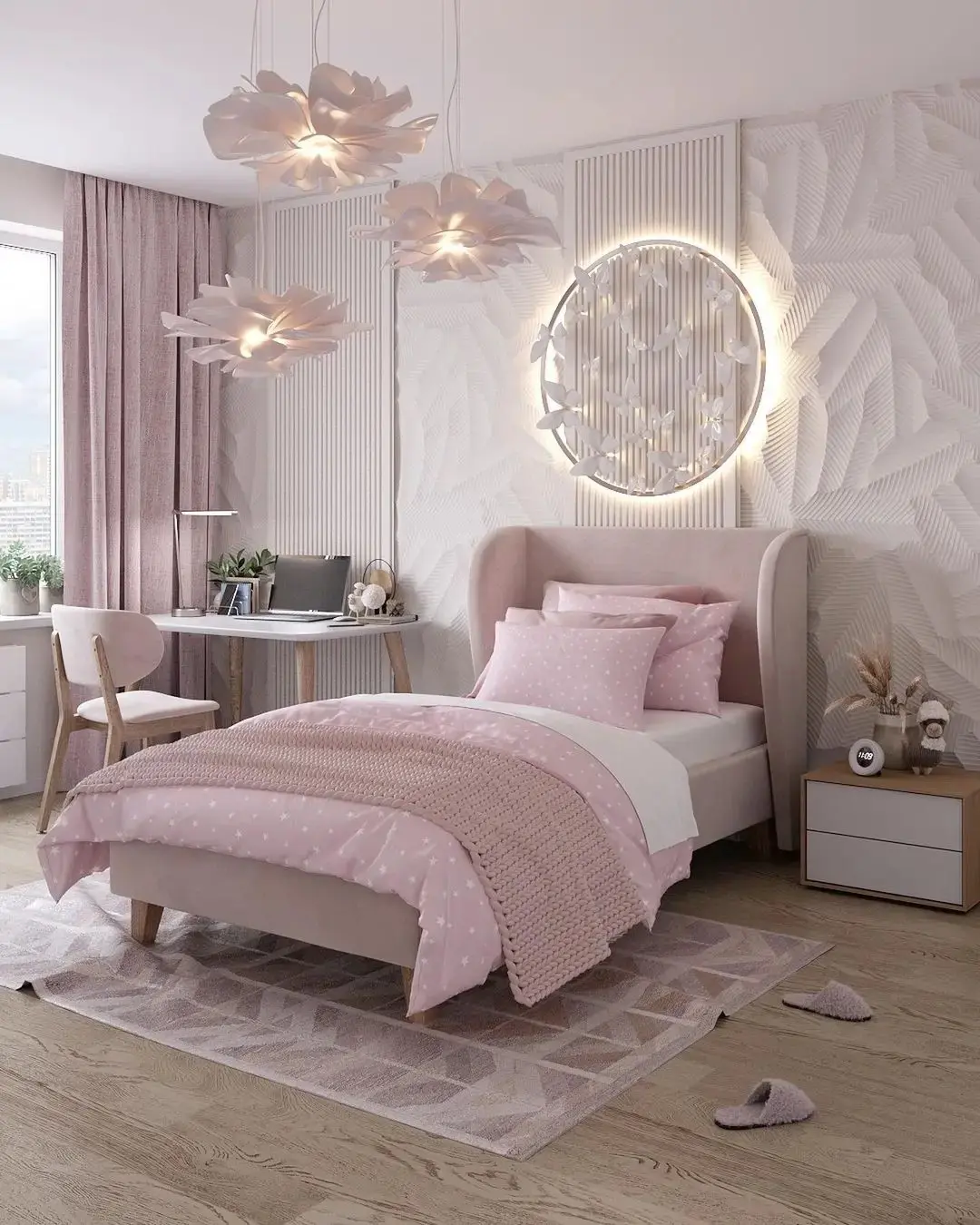 A neatly arranged bedroom featuring a beige bed with pink bedding and pillows, a white and beige rug, a study desk by the window, decorative pendant lights, and a round illuminated wall decor—a perfect example of one of 17 Pink Bedrooms Fit for a Princess.