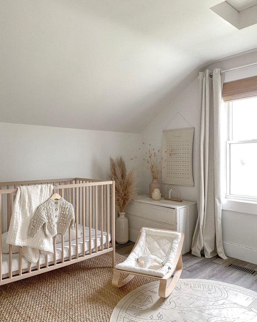 A serene nursery room with a light wood crib, white rocking chair, and decor in bohemian-inspired neutral tones. Natural light streams through a window.
