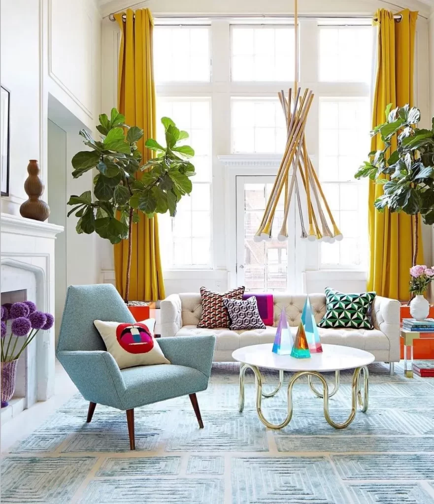 a living room with a lot of personality using a mix of colors and furniture styles nicely complement this funky interior.
