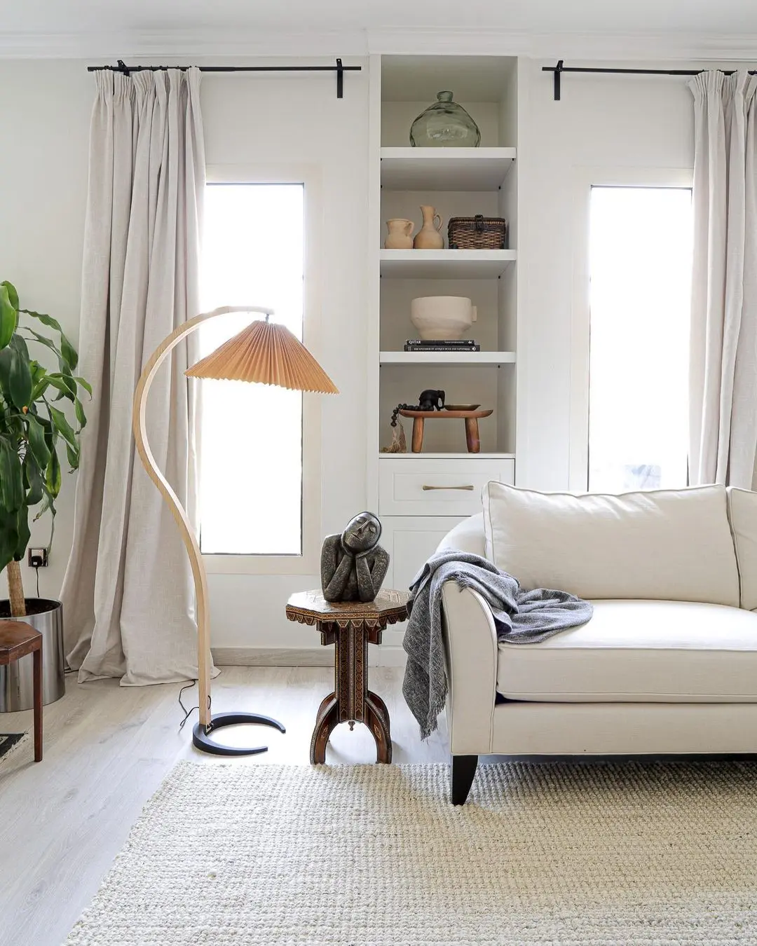 a rental space can easily be personalized by adding decor items that resonate with oneself and by selecting a few important furnishings such as a couch, end table, floor rug, and floor lamp as in this living room.